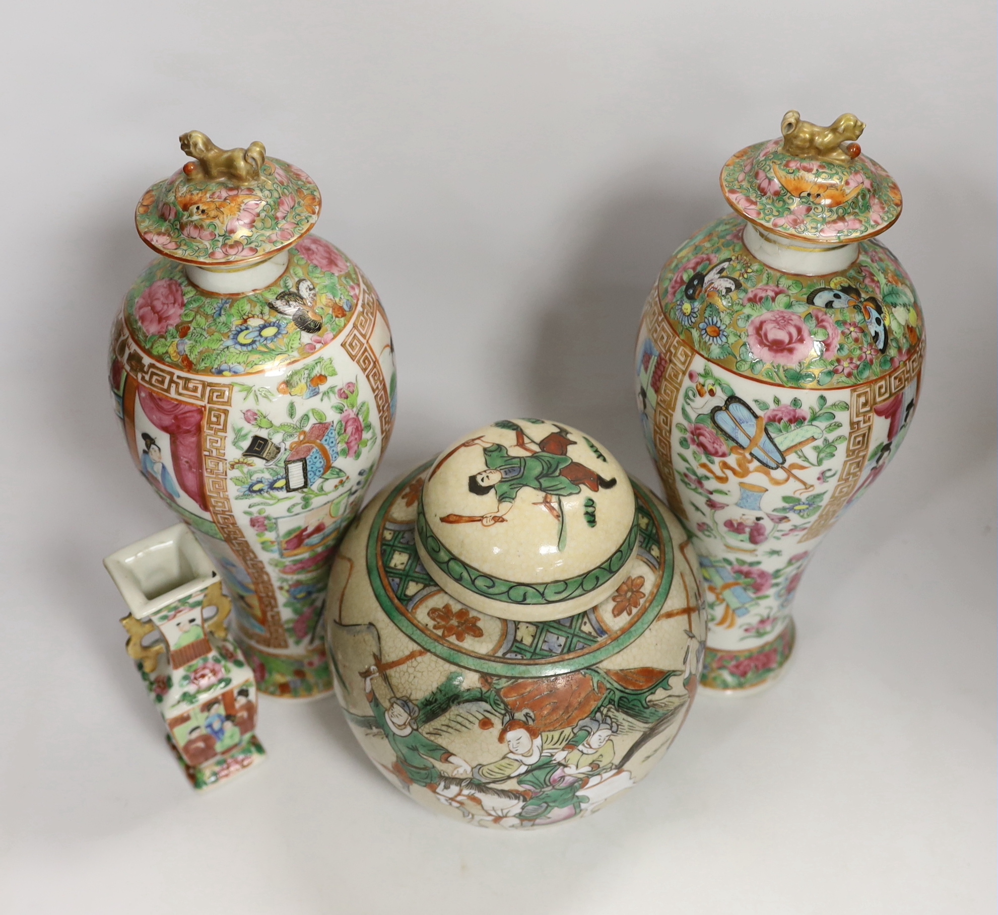 A pair of 19th century Chinese famille rose vases and covers, a similar small vase and a a famille verte crackle glaze jar, tallest 31cm